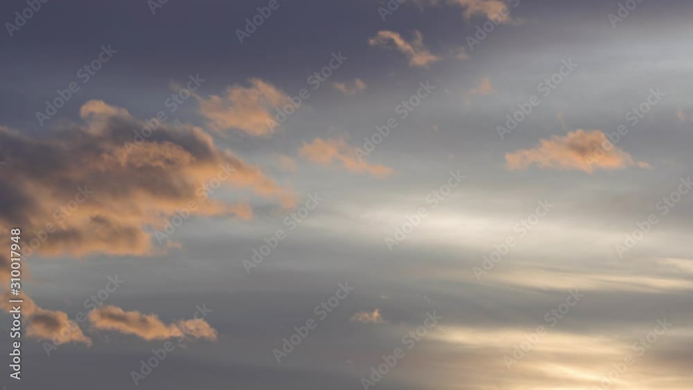 Storm clouds furrow the gray sky at sunset, a beautiful golden backlight ink the sky of yellow and orange colors Storm clouds furrow the gray sky at sunset, a beautiful golden backlight ink the sky of yellow and orange colors