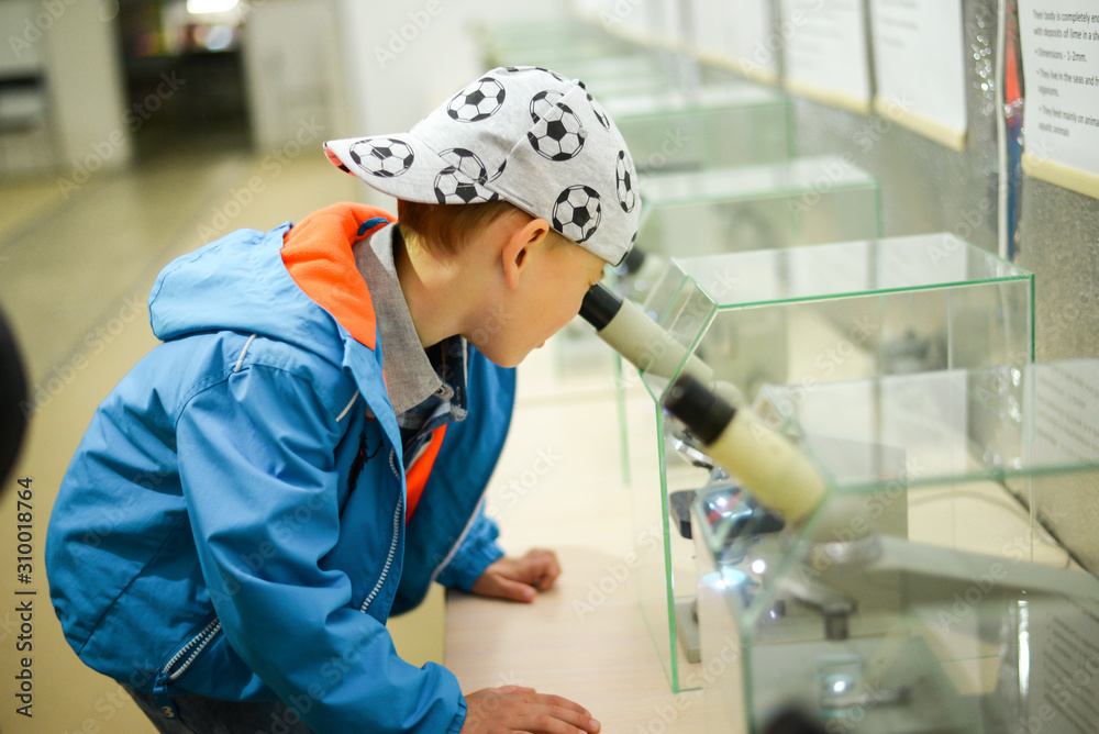 child boy explores looks through microscope child boy explores looks through microscope