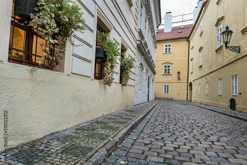 Fototapeta Naklejka Na Ścianę i Meble -  Old street view in Prague, Czech Republic.  Deserted street with paving stones