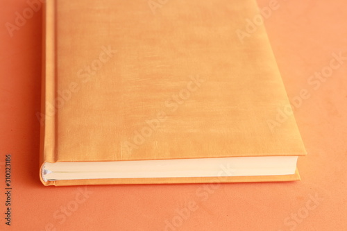 book with orange cover on colorful background