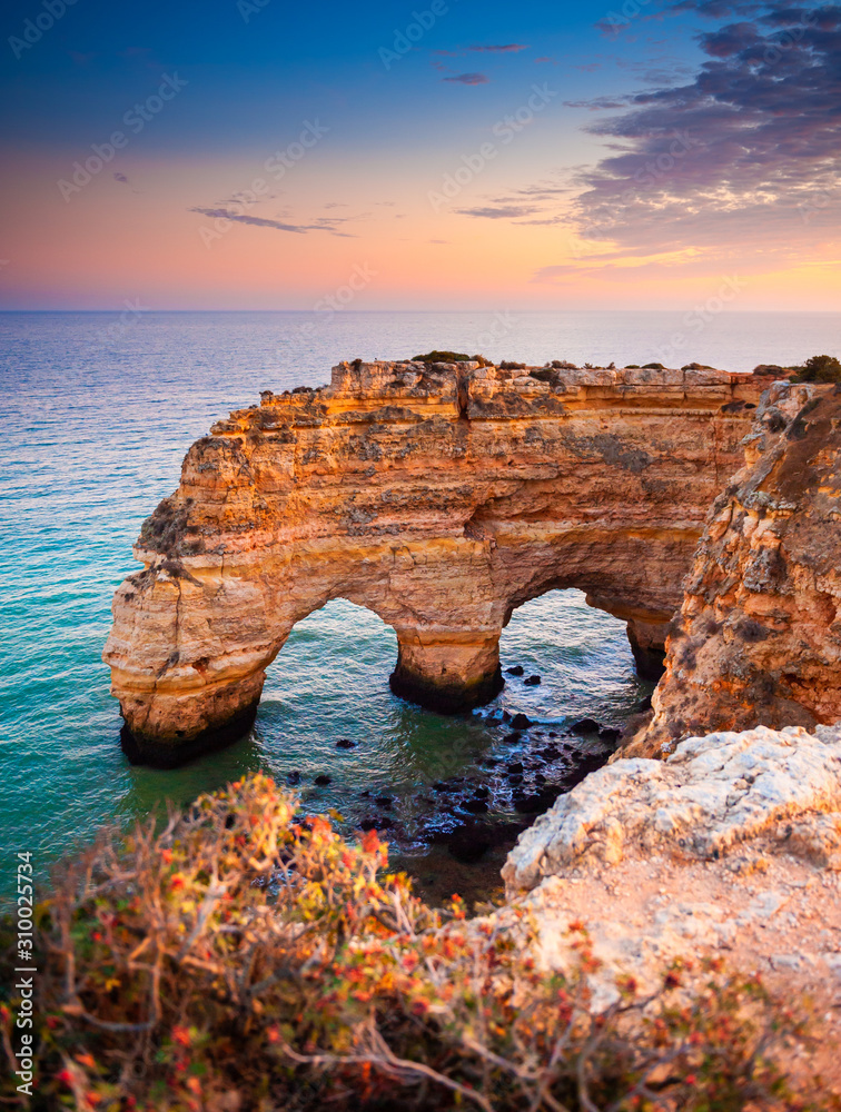 Heart-shaped cliffs on the shore of Atlantic ocean in Algarve, Portugal. Beautiful summer landscape.