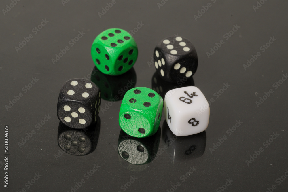 dice on a black background with reflection dice on a black background with reflection