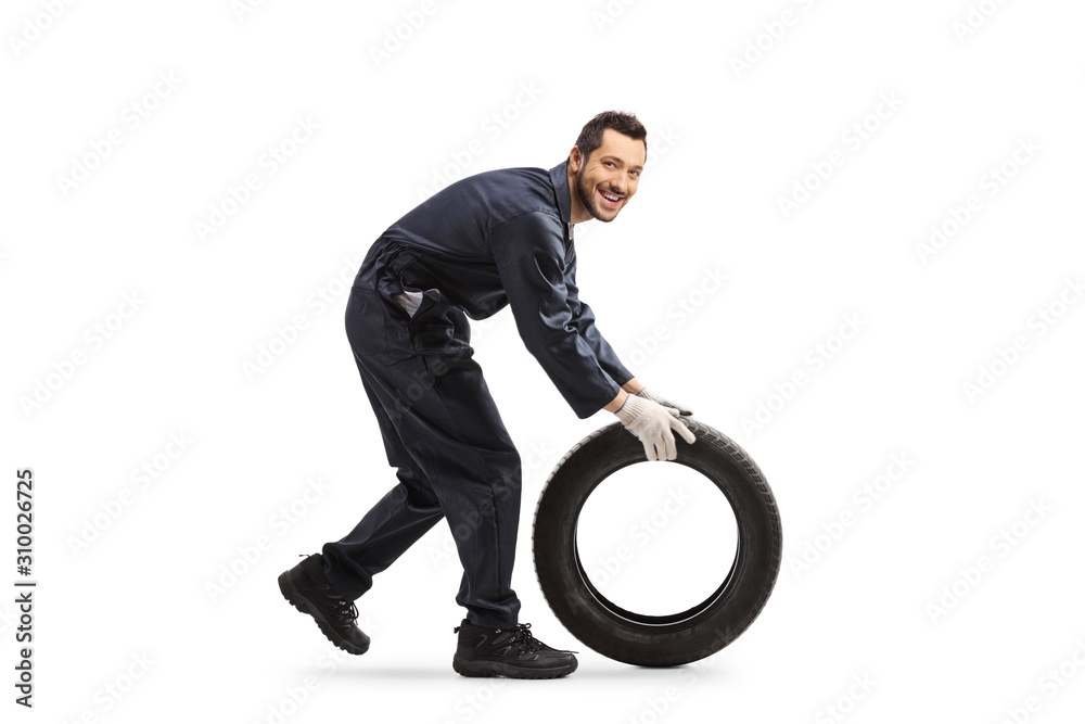 Auto mechanic rolling a car tire Stock Photo Adobe Stock