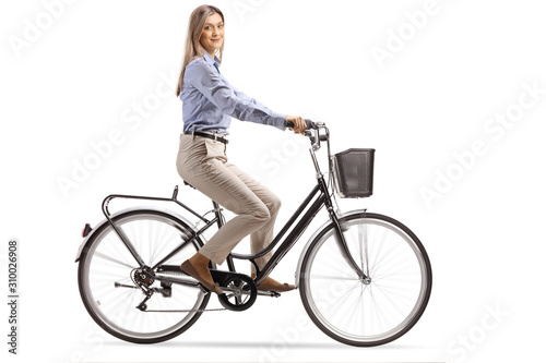 Young woman riding a bicycle and looking at the camera