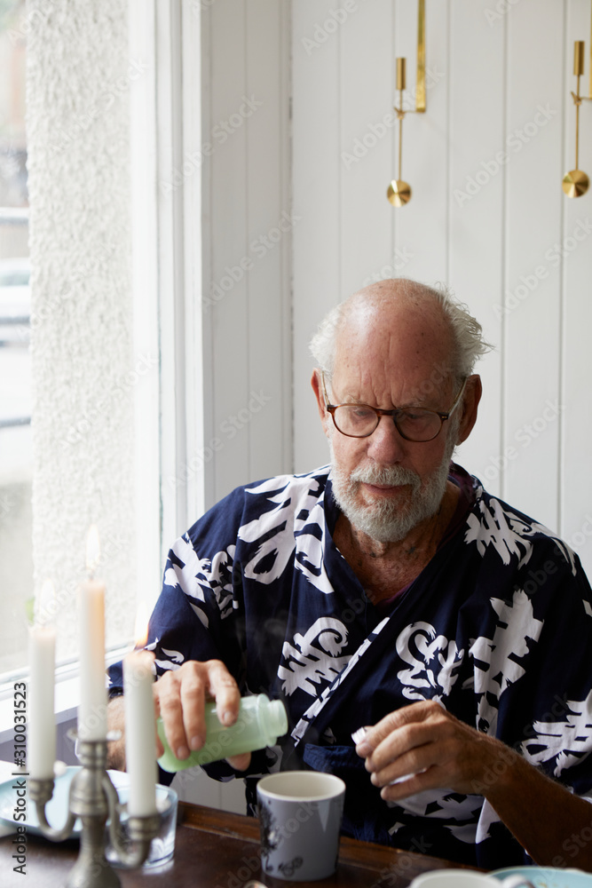 Senior man sitting at table Senior man sitting at table
