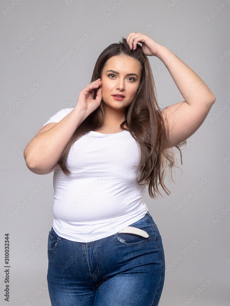 Plus Size Model with long hair posing in studio Plus Size Model with long hair posing in studio