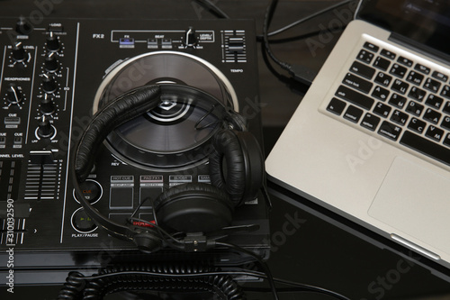  DJ equipment, controller or mixer, headphones, laptop. Music background, banner, card. Modern technologies