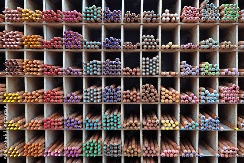 Pencils at the showcase. Colorful pencils for drawing and graphic arts. Drawing education background.
