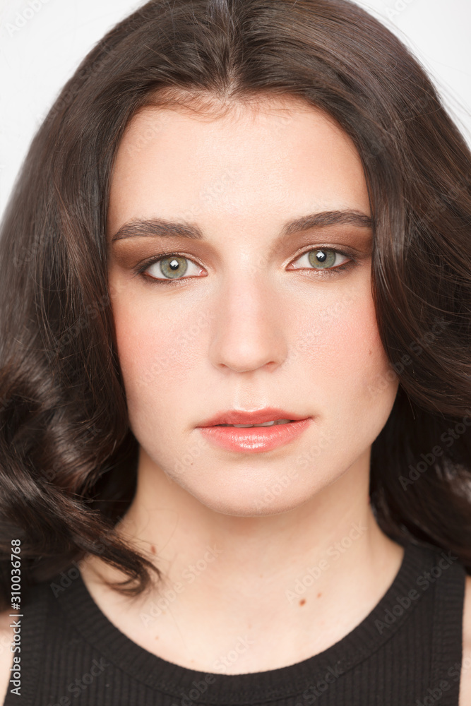 Closeup headshot portrait of a woman with a charming look