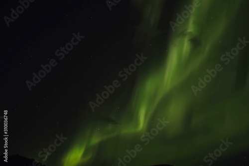 Aurora borealis in night northern sky. Ionization of air particles in the upper atmosphere. © Ludmila