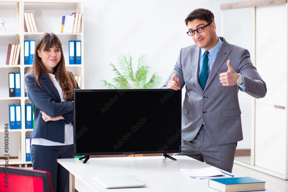 Young employee making presentation to his female boss Young employee making presentation to his female boss