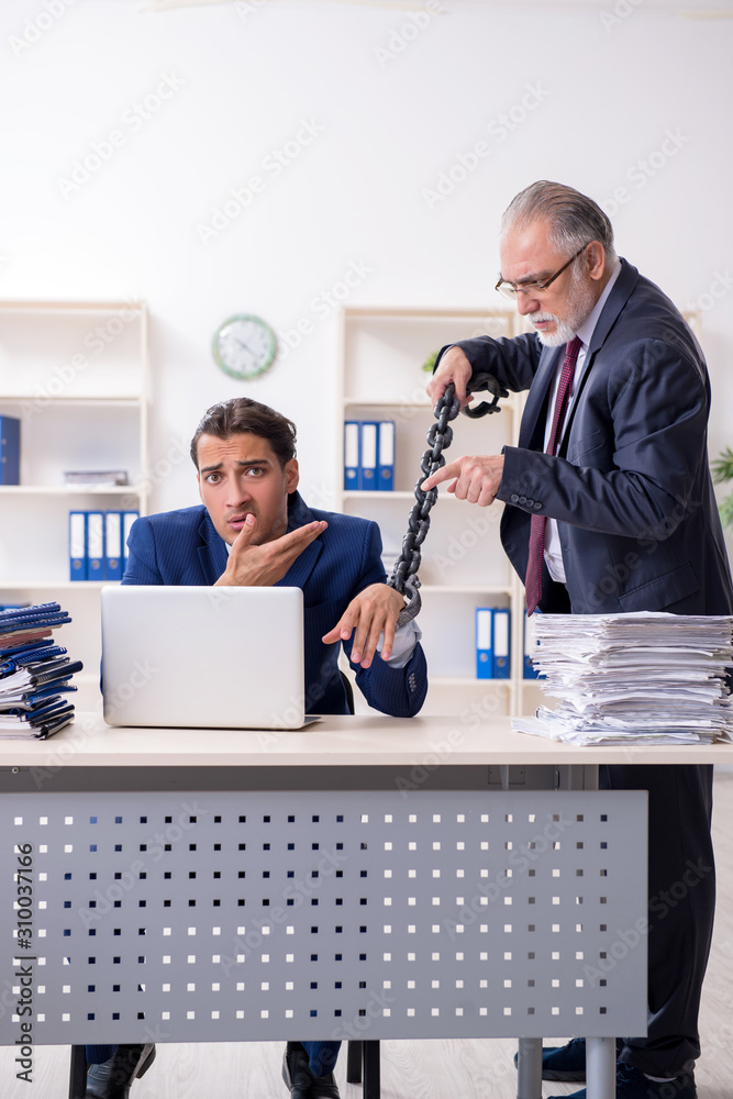 Old boss and young male employee in the office Old boss and young male employee in the office