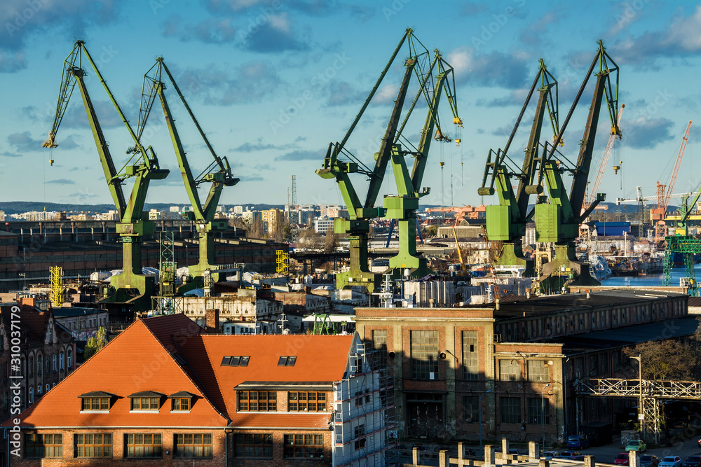 View of the shipyard and port - industry part of the city of Gdansk (Gdańsk) with shipyard constructions and cranes. Poland
