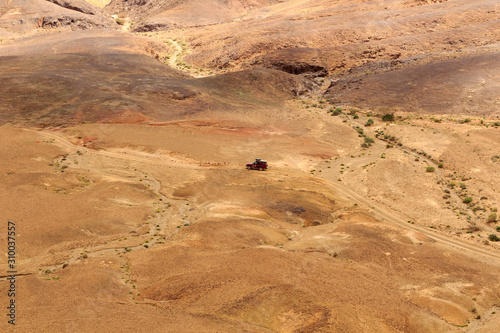 Jeep driving off-road through crater Makhtesh Ramon, Negev Desert, Israel