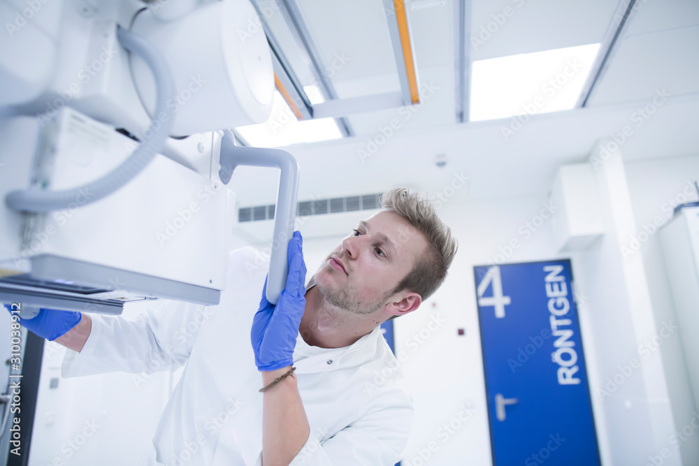 Radiologist adjusting a x-ray machine in a hospital
