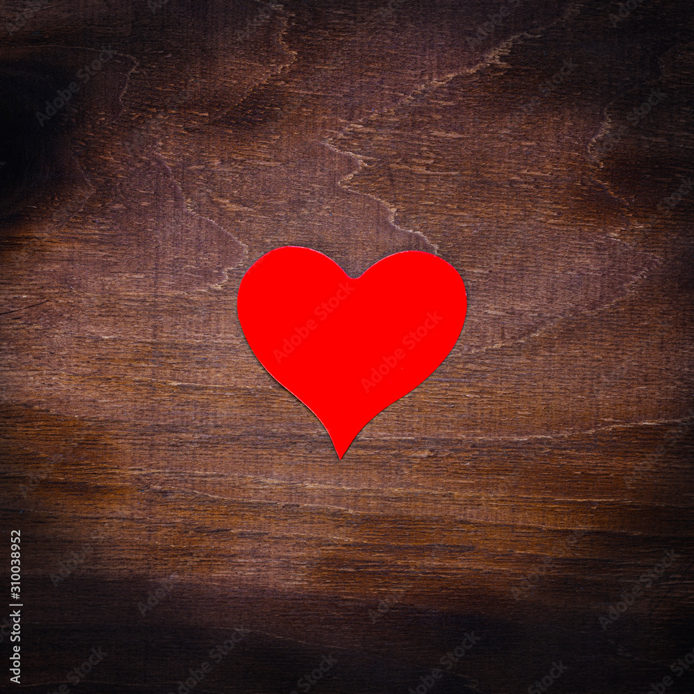 Red paper heart isolated on wooden background Red paper heart isolated on wooden background