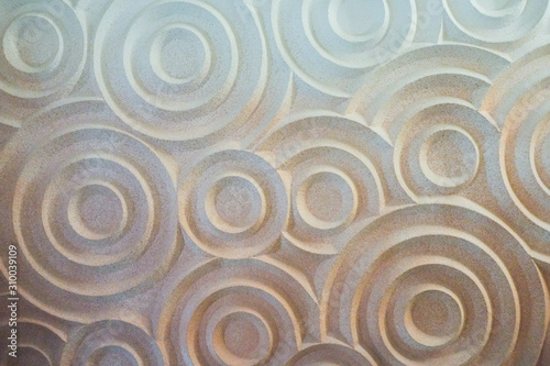 Abstract sand circles textured, three-dimensional white sand circles. Abstract round shapes. Close up . Zen garden pattern on the sand as the background, top view. Meditation and harmony