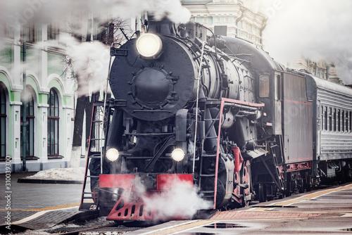 Steam train departs from the railway station. Moscow.