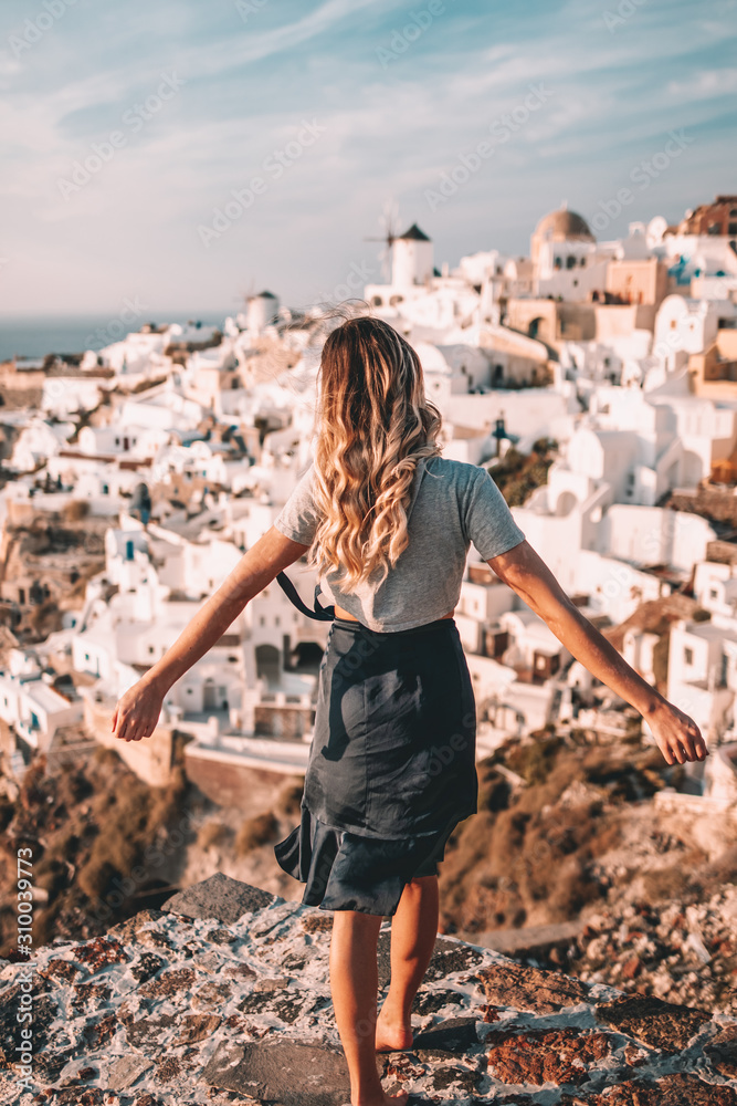 Young woman during sunset on oia viewpoint Young woman during sunset on oia viewpoint