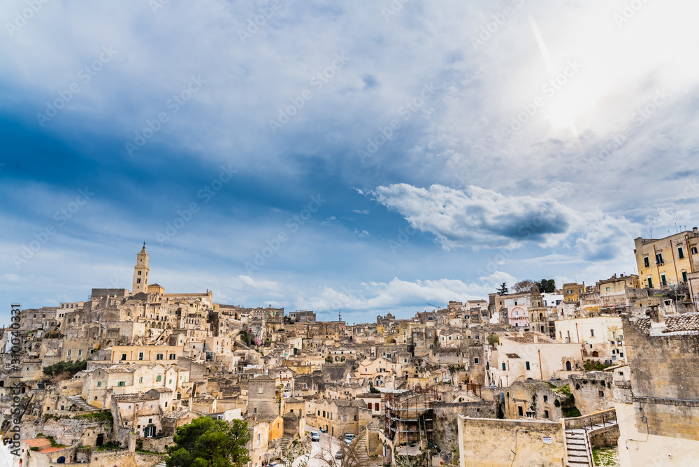 Long panoramic views of the rocky old town of Matera with its stone roofs.