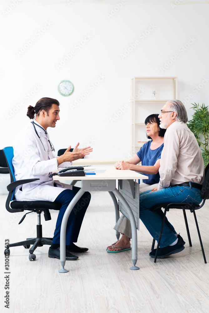 Old couple visiting young male doctor Old couple visiting young male doctor