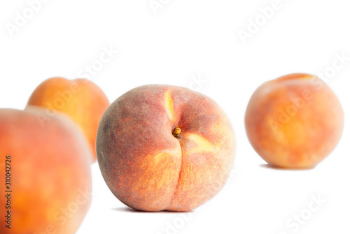 Four peaches on a white background