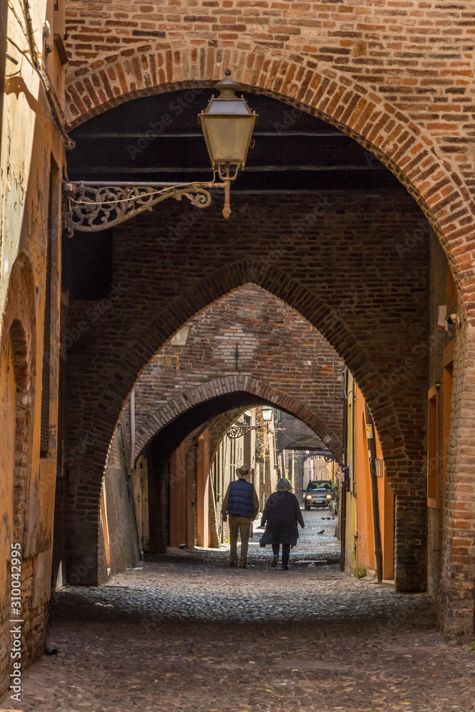 Walking in the old center of Ferrara, Italy
