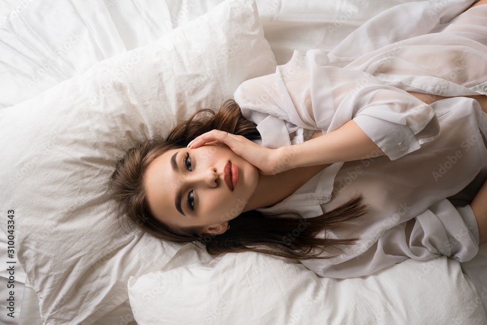 Sexy brunette in unbuttoned shirt in bed Sexy brunette in unbuttoned shirt in bed