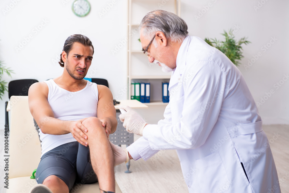 Fototapeta premium Young male patient visiting experienced doctor