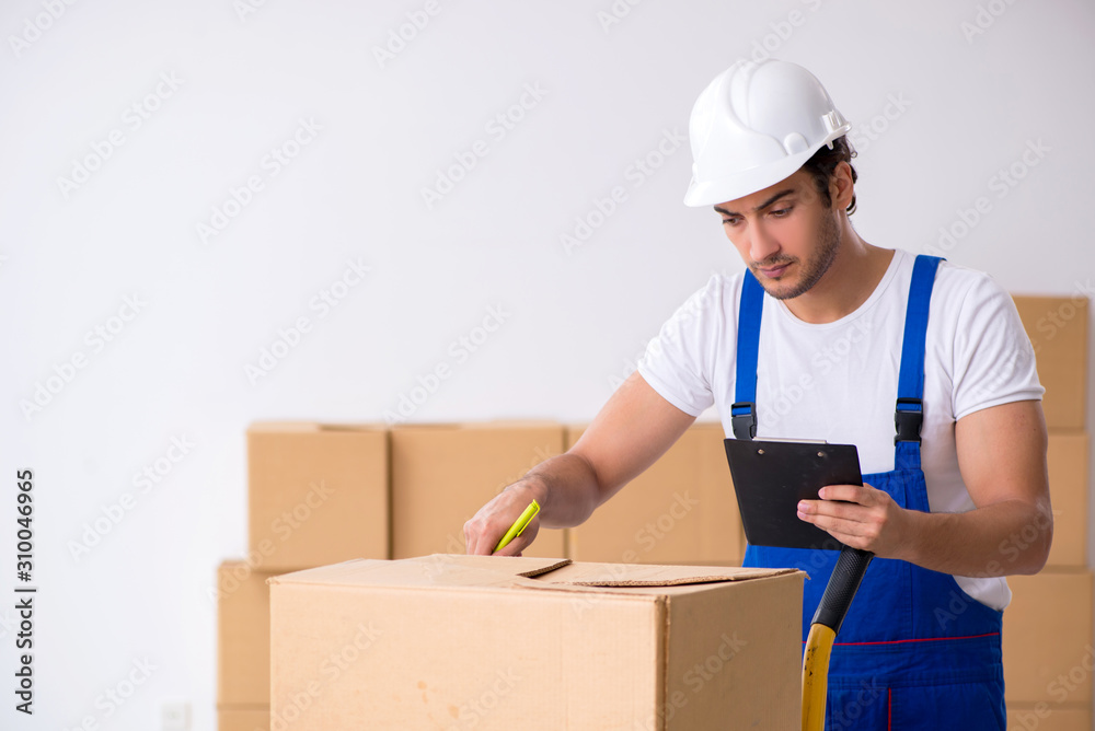 Young male professional mover doing home relocation Young male professional mover doing home relocation