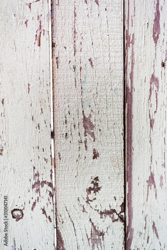 Wall of the old wooden boards. Fence made of rough painted boards. Close up. Vertical