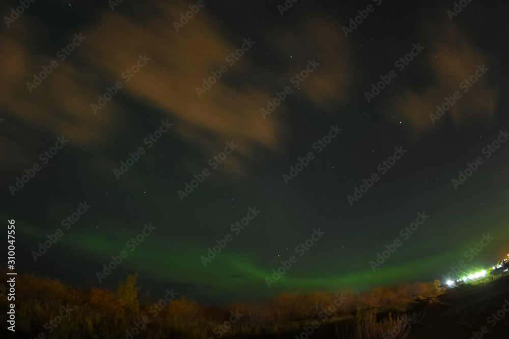 Fototapeta premium Aurora borealis in night northern sky. Ionization of air particles in the upper atmosphere.