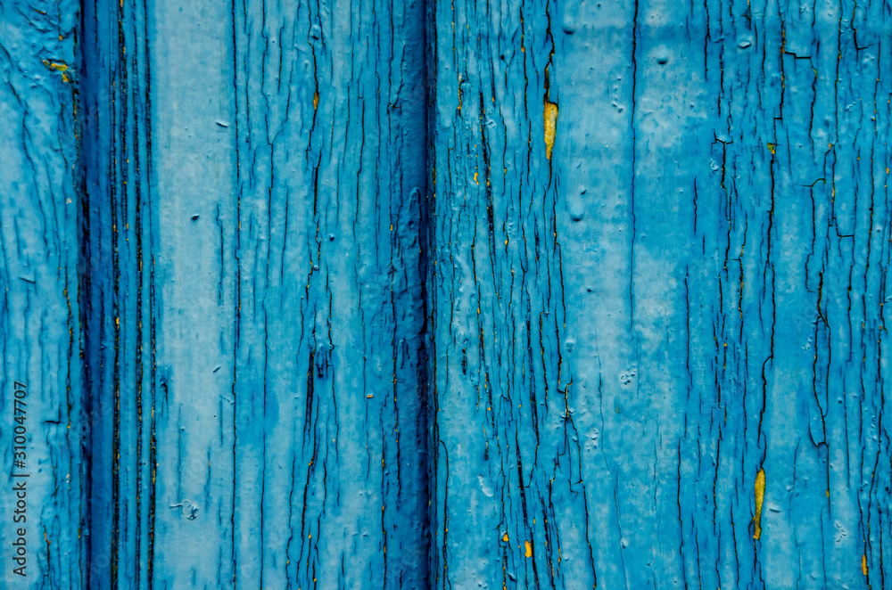 Empty background painted wooden surface. Old blue paint on the board. Cracked and chipped. Wood texture. Empty background painted wooden surface. Old blue paint on the board. Cracked and chipped. Wood texture.