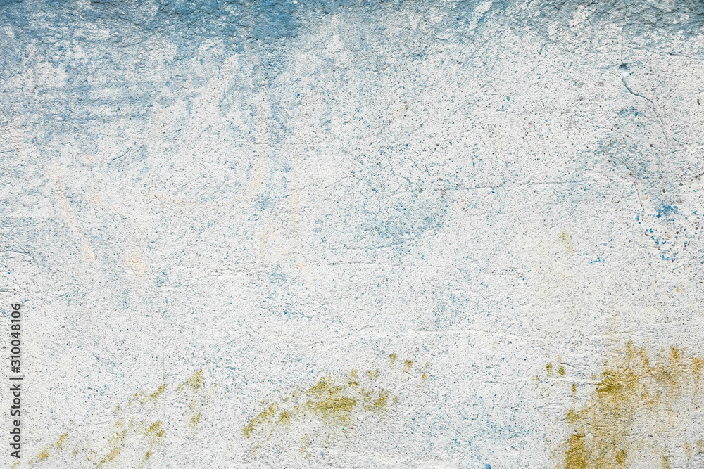 Abstract texture of old colorful wall with grain and scratches. Beautiful, artistic, creative background. White, yellow and blue rough weathered stone texture. Copy space	