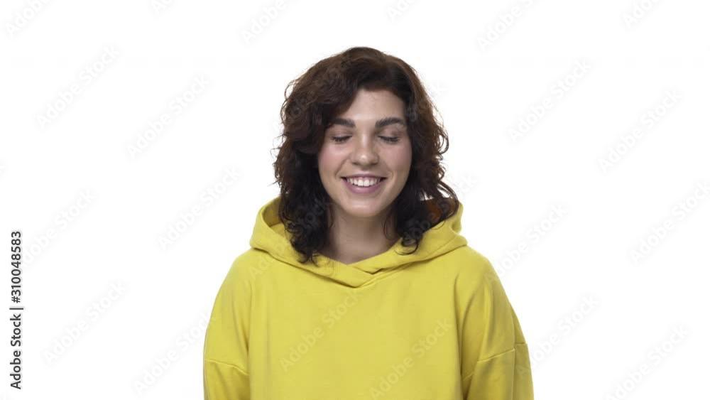 Lovely, flirty cheerful curly-haired caucasian modern woman in yellow hoodie, glancing camera shy or blushing, smiling silly and tender as coquettish talking, express happiness and sympathy Lovely, flirty cheerful curly-haired caucasian modern woman in yellow hoodie, glancing camera shy or blushing, smiling silly and tender as coquettish talking, express happiness and sympathy