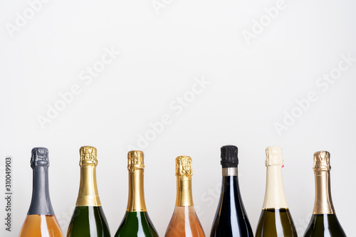Collection of various champagne bottles on white. Pink, White and Green Bottles. sparkling wine.