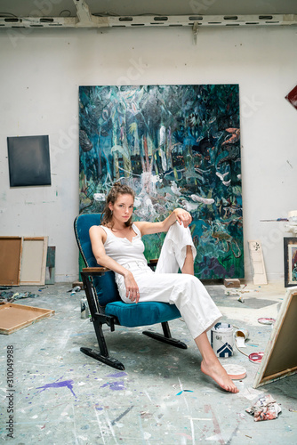 Young artist sitting in her studio