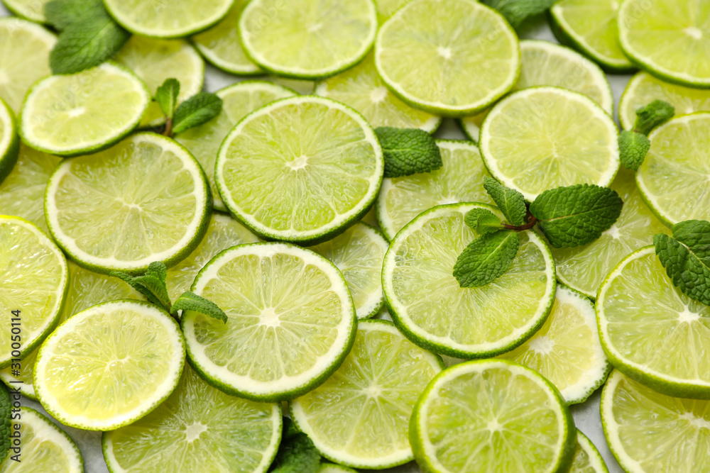 Slices of fresh juicy limes as background, closeup Slices of fresh juicy limes as background, closeup