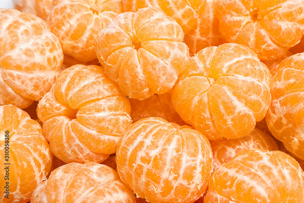 Peeled fresh ripe tangerines as background, closeup Peeled fresh ripe tangerines as background, closeup