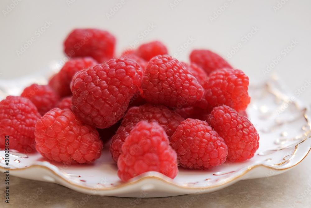 Juicy, ripe, raspberry berry on a white plate. A new harvest. Juicy, ripe, raspberry berry on a white plate. A new harvest.