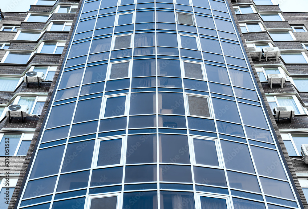 Modern building with tinted windows, low angle view Modern building with tinted windows, low angle view
