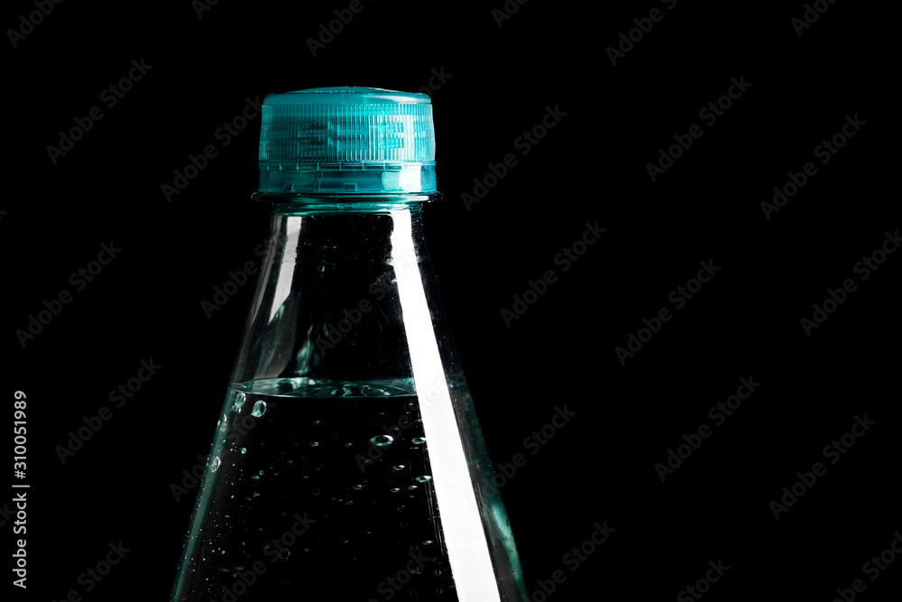 plastic bottle of water isolated on a black background. Image for design.