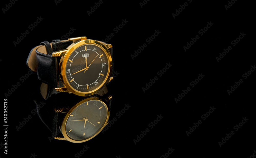 Luxury style golden wrestwatch on black cloth close up view Luxury style golden wrestwatch on black cloth close up view