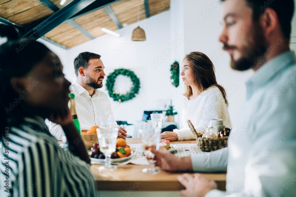 Friends talking at Christmas table