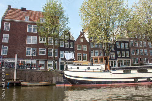 Amsterdam Canal with traditional old Houses and Trees.Landscape and culture travel, or historical building and sightseeing concept.
