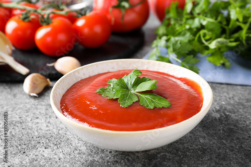 Delicious fresh tomato sauce on grey table, closeup