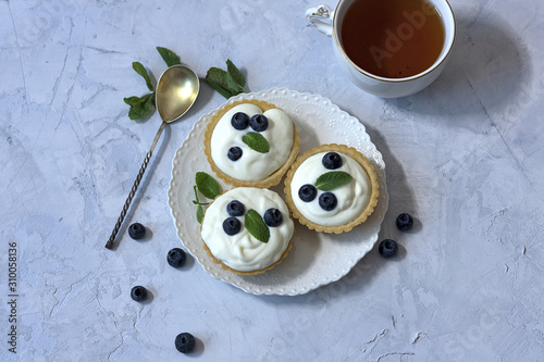 Homemade Tartlets with cream cheese and fresh berries - blueberry, top view