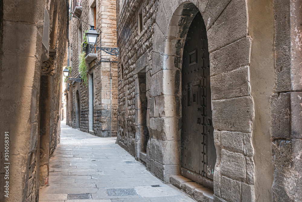 Empty street in Barcelona within the Gothic quarter. Picturesque deserted alley in Spain