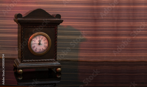 Vintage style alarm clock on wooden background banner with copy space