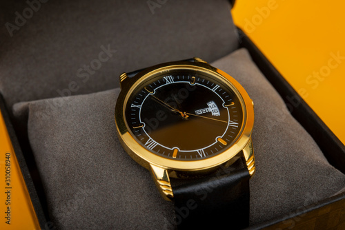 Luxury style golden hand watch in gift box close up view